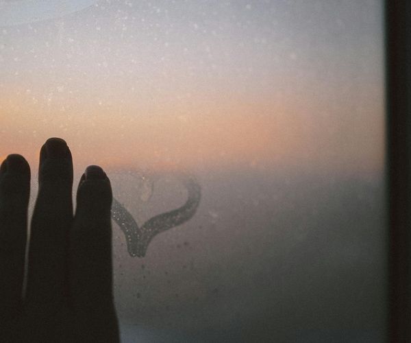 Person stretching gently by a window with soft morning light.